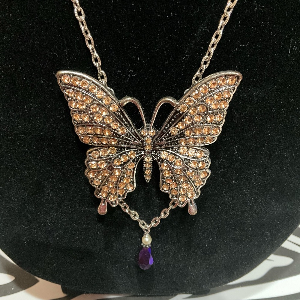 Fancy butterfly pendant. Amber stones. Purple drop at bottom. Beautiful.